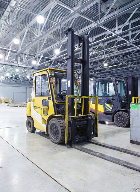 bigstock-Two-loaders-in-modern-storehou-26381078